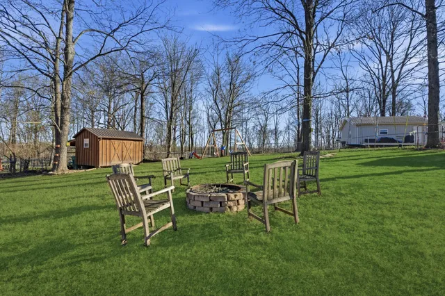a wooden bench sitting in middle of a field