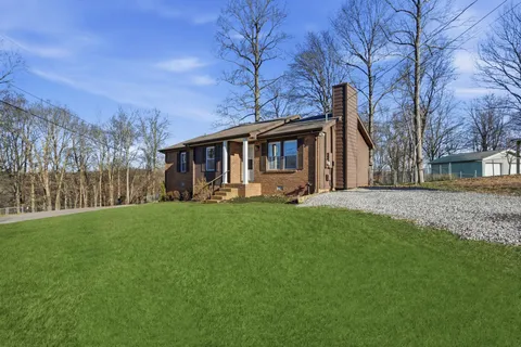 a front view of house with yard and green space