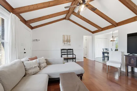 a living room with furniture and wooden floor
