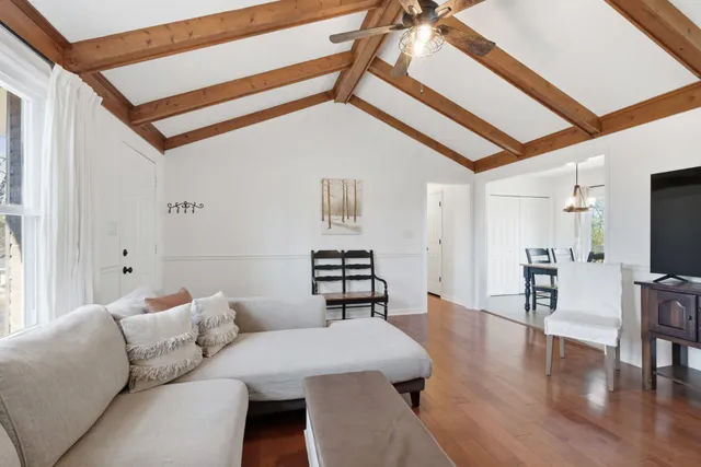 a living room with furniture and wooden floor
