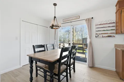 a view of a dining room with furniture window and wooden floor