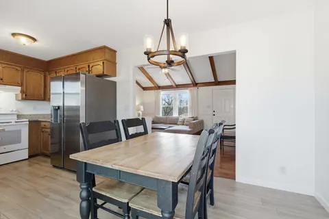 a view of a dining room with furniture and wooden floor