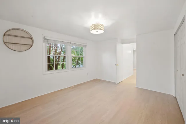a bathroom with a sink toilet vanity and window