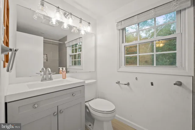 a bedroom with a large bed and a flat tv screen on dresser