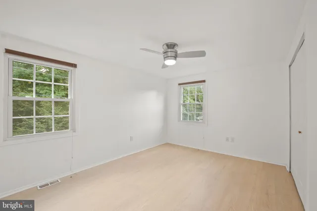a view of empty room with ceiling fan