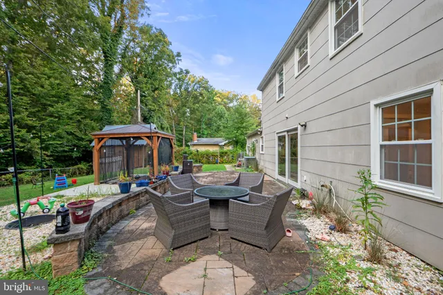 a view of a house with backyard and sitting area