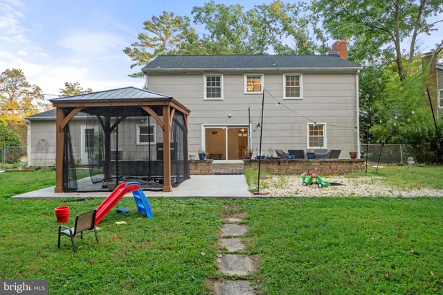 front view of a brick house with a yard