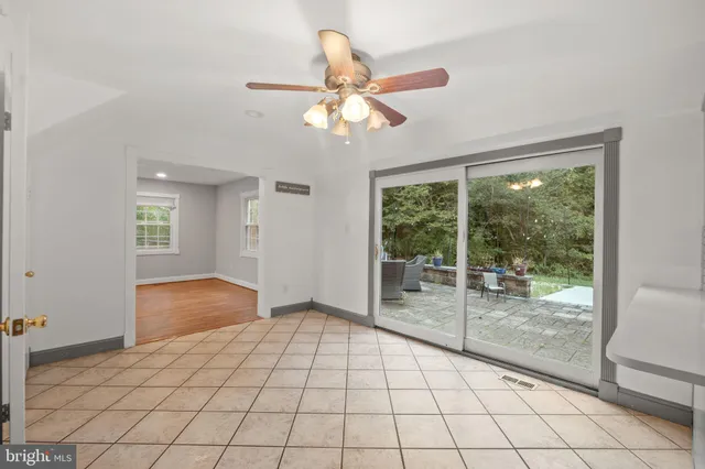 a view of a room with a fireplace cabinet and windows