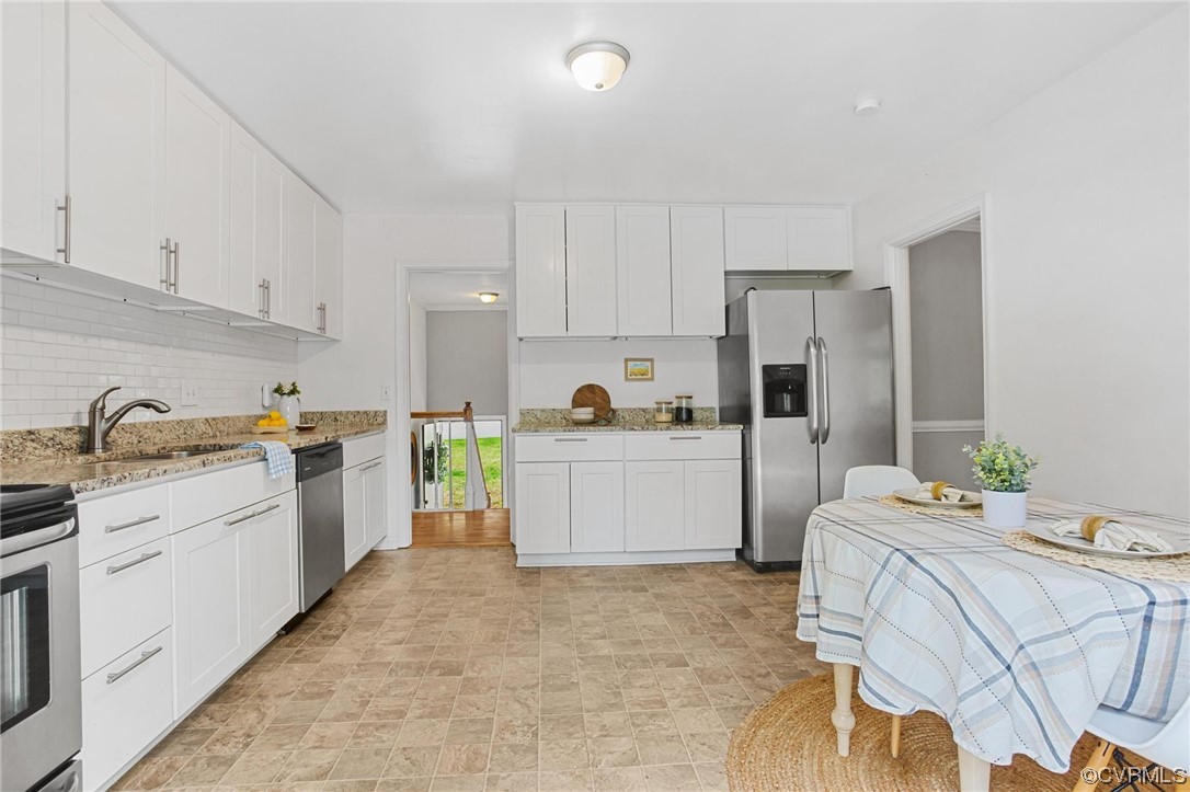 12912 Middlebrook Road Chester, VA 23831 - Photo 15 of 43 a kitchen with white cabinets and white appliances