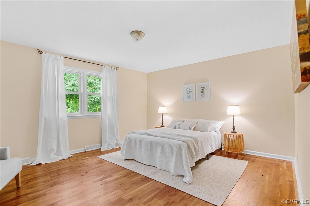 12912 Middlebrook Road Chester, VA 23831 - Photo 17 of 43 a bedroom with a bed and a lamp