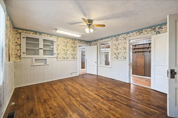 wooden floor in an empty room with a window
