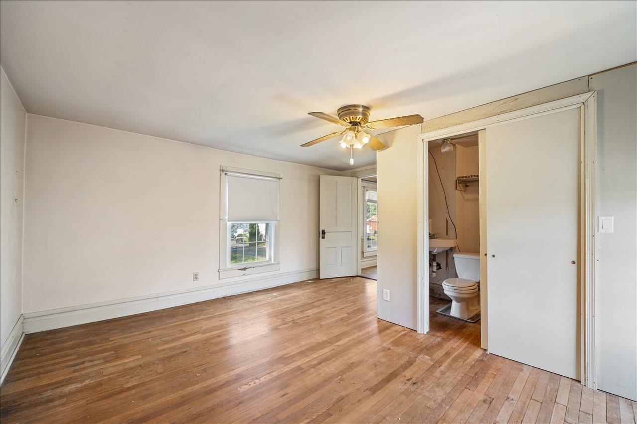 35 Tinkling Spring Road Fishersville, VA 22939 - Photo 30 of 39 an empty room with wooden floor and a ceiling fan