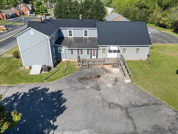 an aerial view of a house with a yard