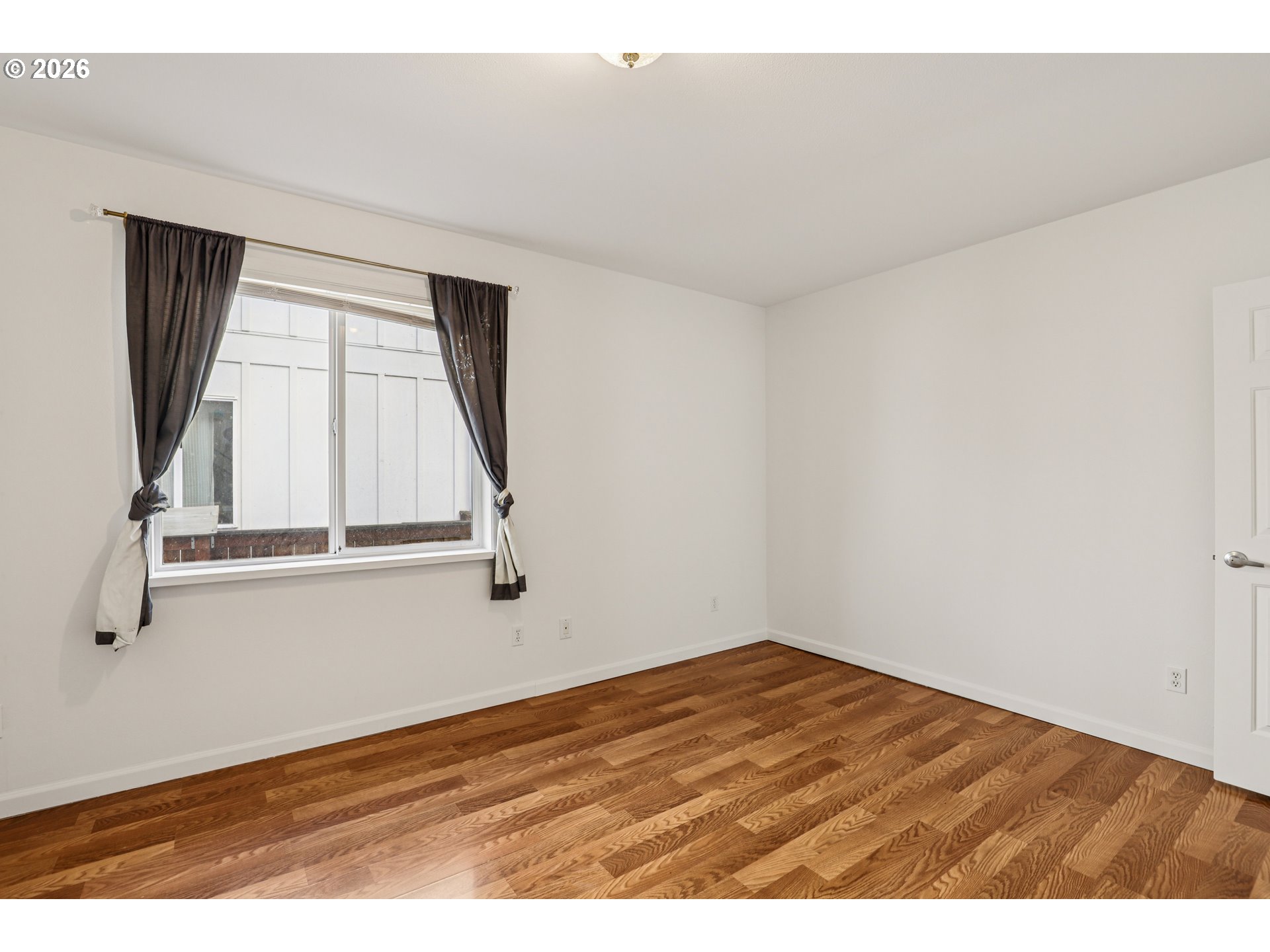 1005 Northeast 72nd Avenue Portland, OR 97213 - Photo 15 of 41 a view of an empty room with wooden floor and a window