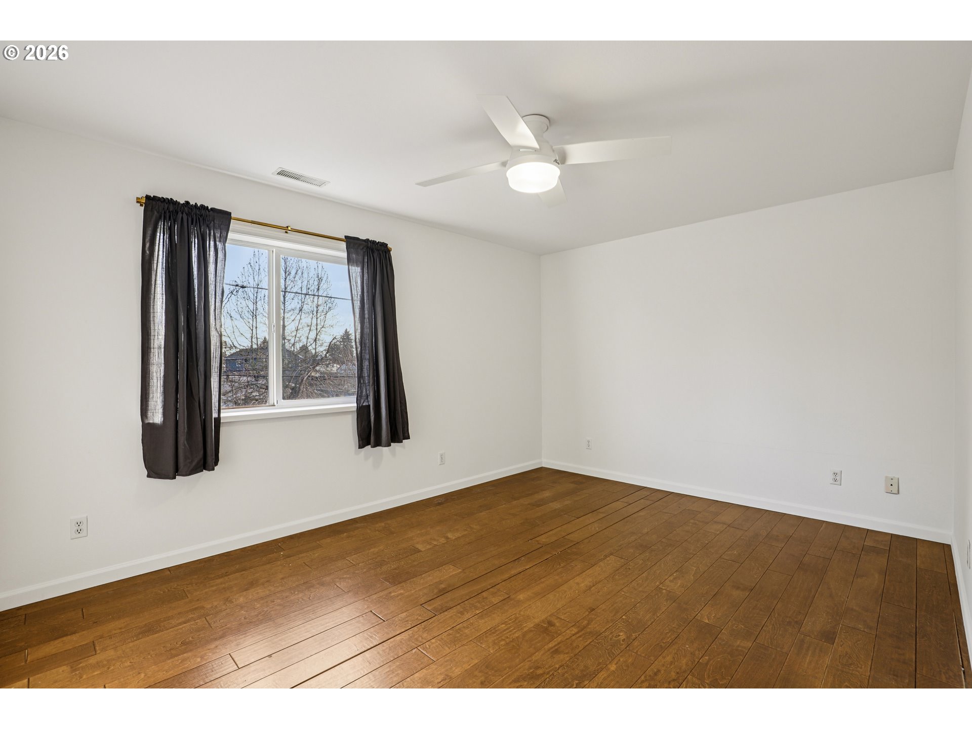 1005 Northeast 72nd Avenue Portland, OR 97213 - Photo 19 of 41 an empty room with windows and fan