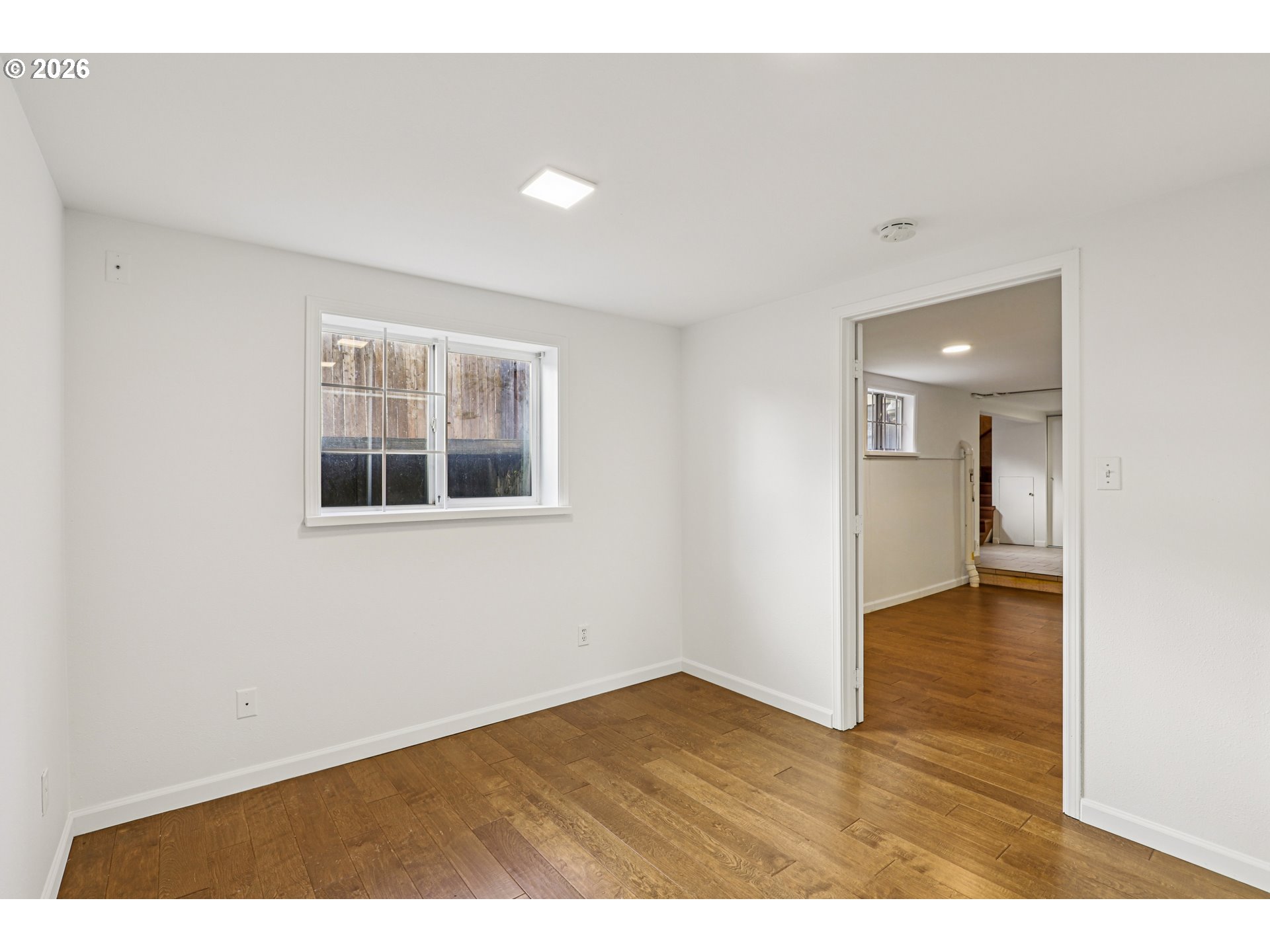 1005 Northeast 72nd Avenue Portland, OR 97213 - Photo 31 of 41 a view of an empty room with wooden floor and a window