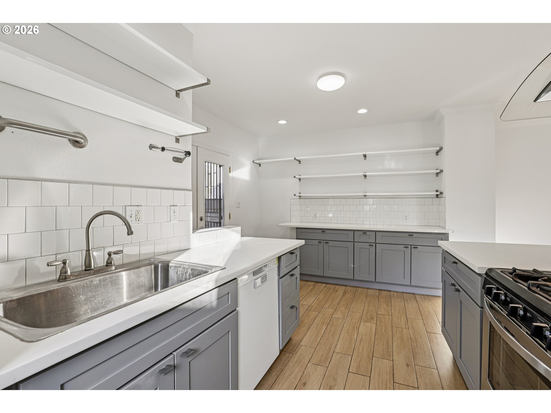 1005 Northeast 72nd Avenue Portland, OR 97213 - Photo 10 of 41 a kitchen with a sink stove top oven and cabinets