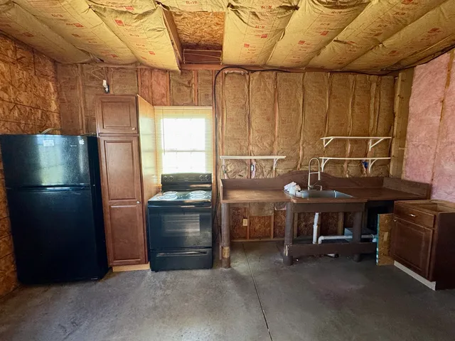 a kitchen with refrigerator and stove