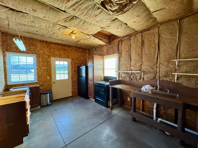 a large kitchen with stainless steel appliances granite countertop a stove and a sink