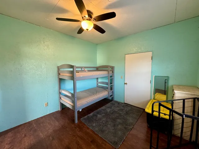 a bedroom with furniture and a ceiling fan
