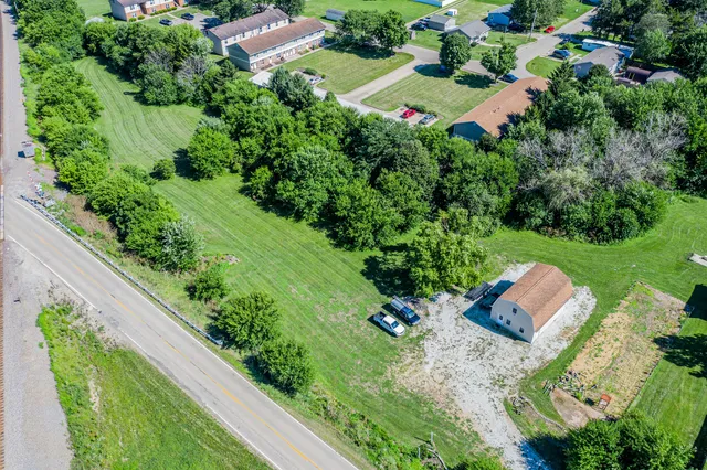 an aerial view of a house with a yard