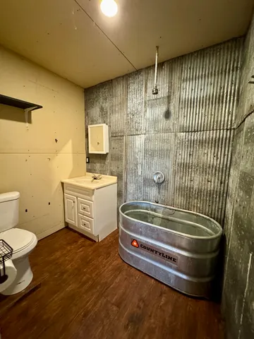 a bathroom with a sink a toilet and shower