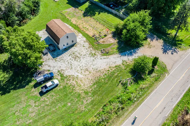 an aerial view of a house with a yard and garden