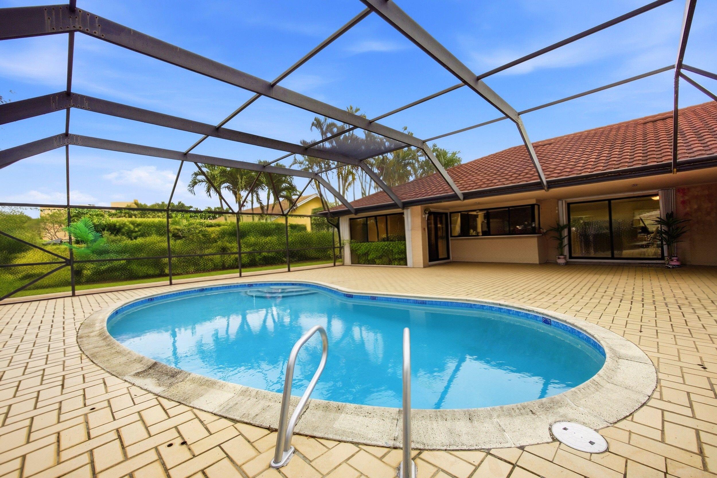 375 Northwest 53rd Street Boca Raton, FL 33487 - Photo 14 of 14 a view of a swimming pool with a patio