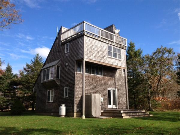 95 Litchfield Road Edgartown, MA 02539 - Photo 1 of 20 a front view of a house with a garden