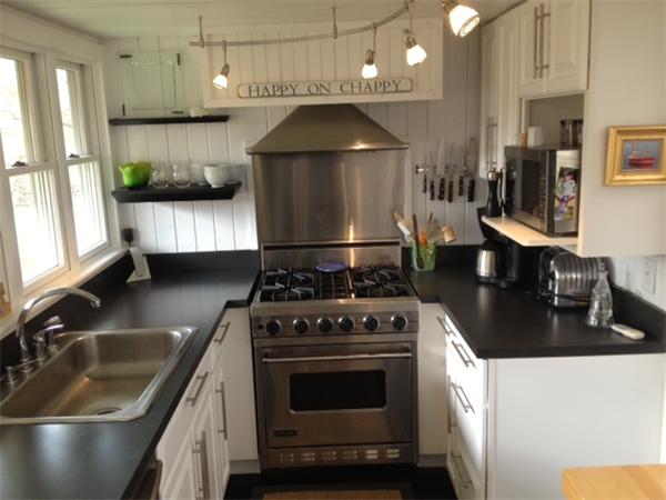 95 Litchfield Road Edgartown, MA 02539 - Photo 3 of 20 a kitchen with granite countertop a stove a sink and a cabinets
