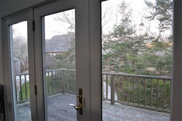 95 Litchfield Road Edgartown, MA 02539 - Photo 7 of 20 a view of a glass door and a yard from a window