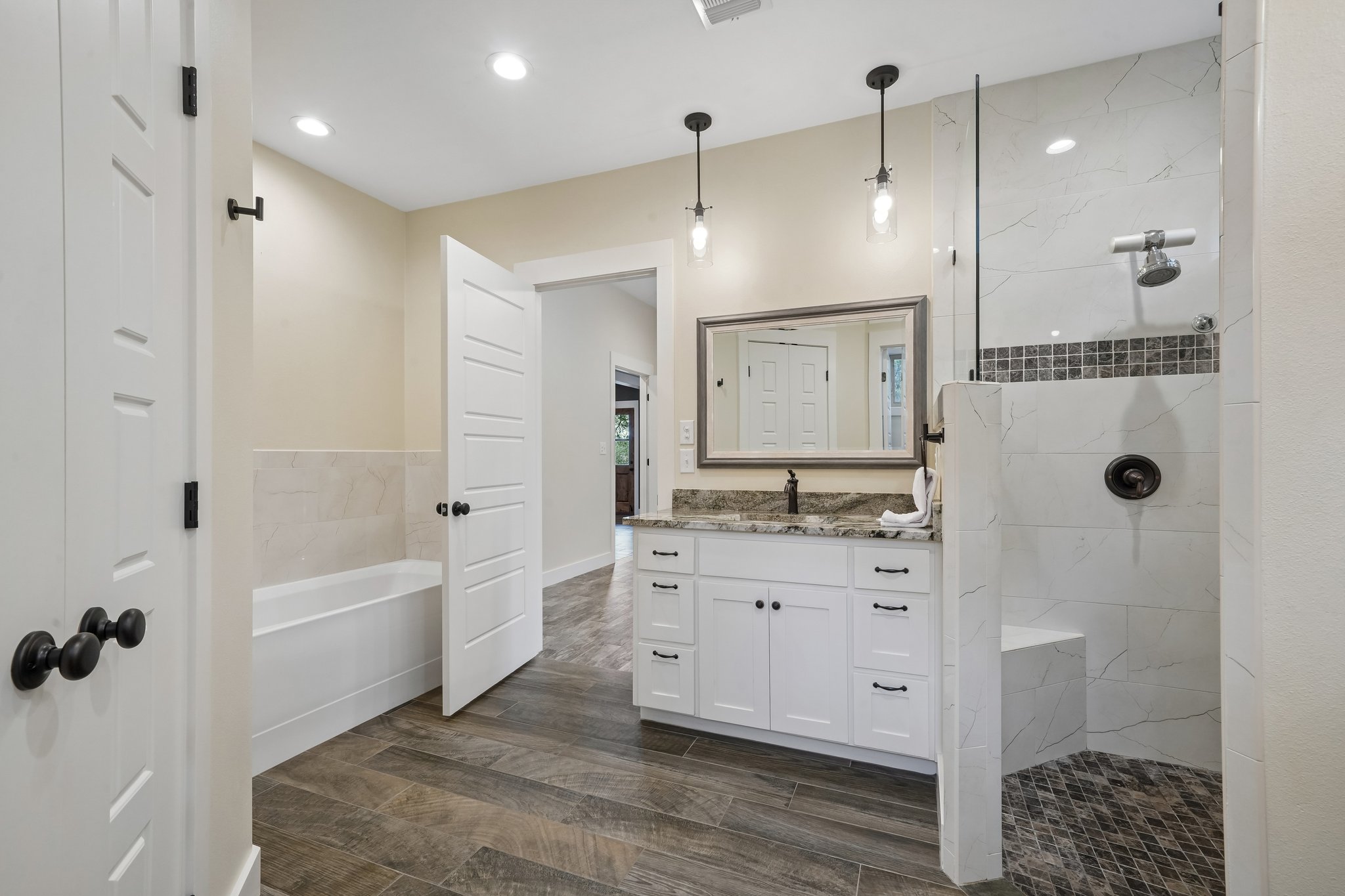 190 Magnolia Meadow Spring Branch, TX 78070 - Photo 12 of 29 Luxurious bathing quarters with a spacious vanity, walk-in shower, and a soaking tub.