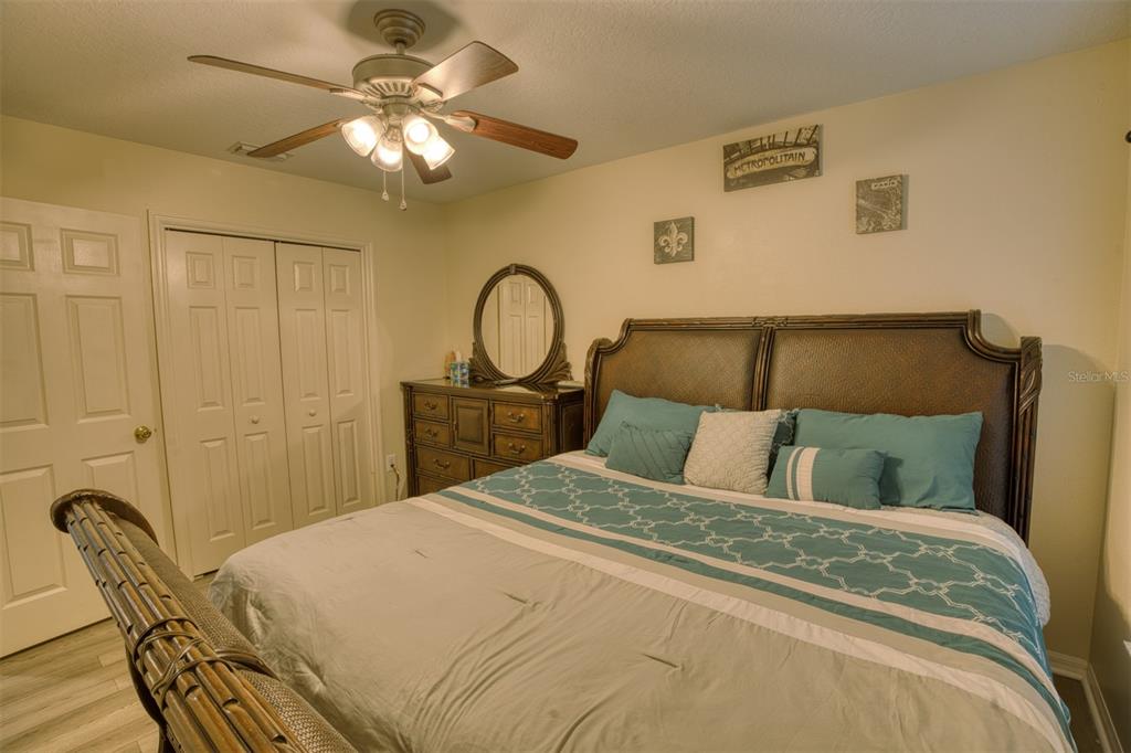 4303 Orange Ridge Court Valrico, FL 33596 - Photo 12 of 40 a bedroom with a bed and a chandelier