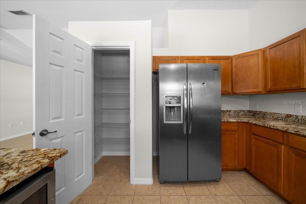 234 Locust Lane Ocala, FL 34472 - Photo 51 of 71 a kitchen with stainless steel appliances granite countertop a refrigerator and a sink