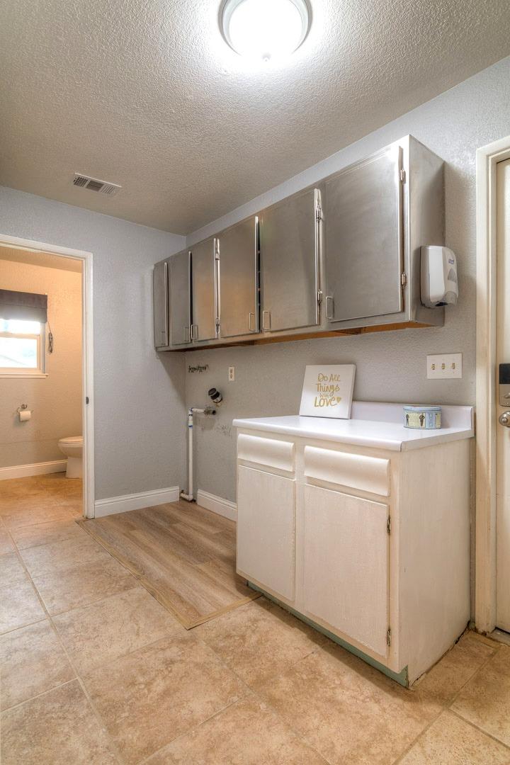 7535 Baldwin Street Valley Springs, CA 95252 - Photo 26 of 35 Laundry with lots of cabinets.