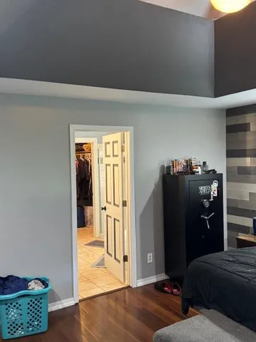 a bedroom with a bed and a window