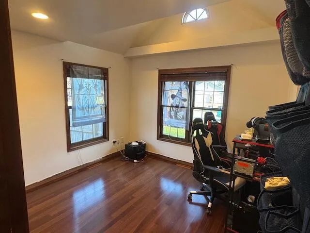 a view of a workspace with furniture and a window