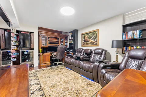 a view of a dining room with furniture one side kitchen view and wooden floor