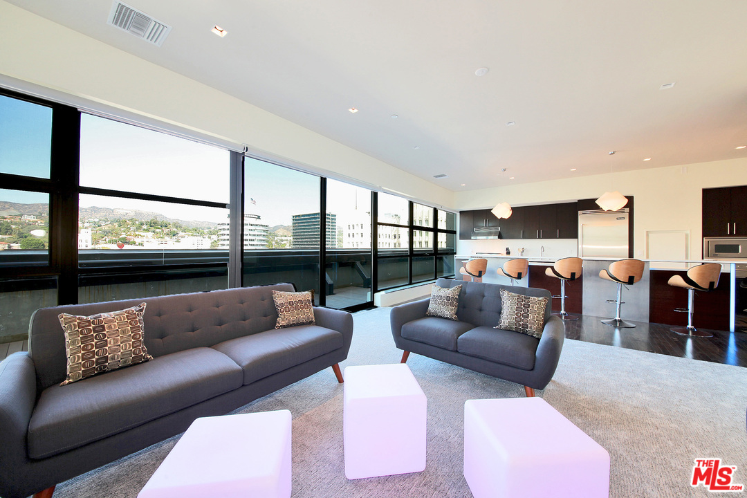 1645 Vine Street, Unit 908 Los Angeles, CA 90028 - Photo 11 of 52 a living room with furniture and a large window
