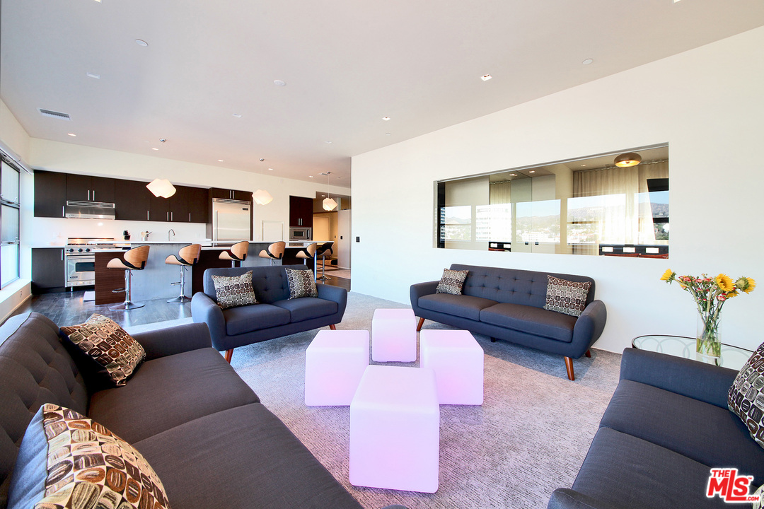 1645 Vine Street, Unit 908 Los Angeles, CA 90028 - Photo 12 of 52 a living room with furniture and a large window