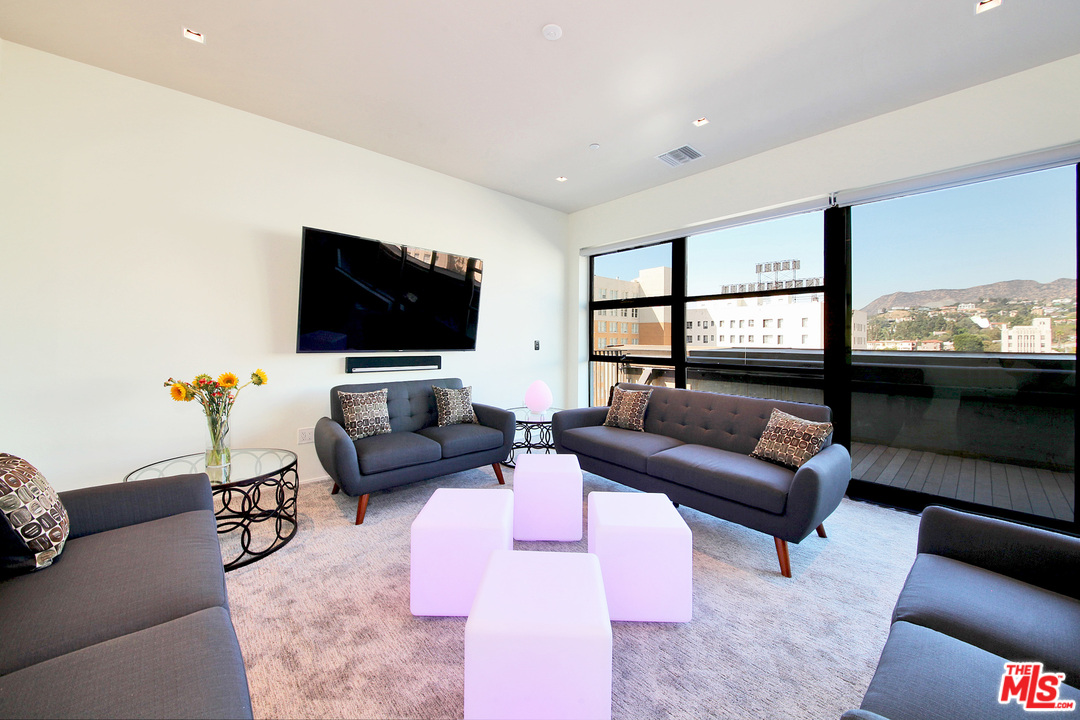 1645 Vine Street, Unit 908 Los Angeles, CA 90028 - Photo 14 of 52 a living room with furniture and a flat screen tv