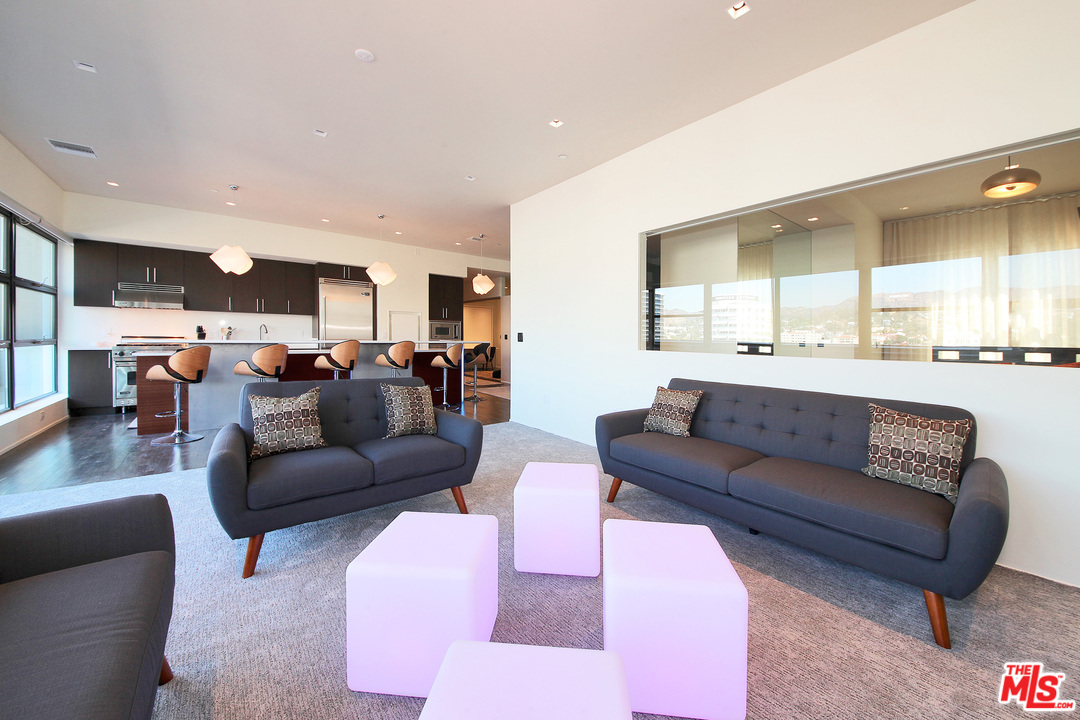 1645 Vine Street, Unit 908 Los Angeles, CA 90028 - Photo 15 of 52 a living room with furniture and kitchen view