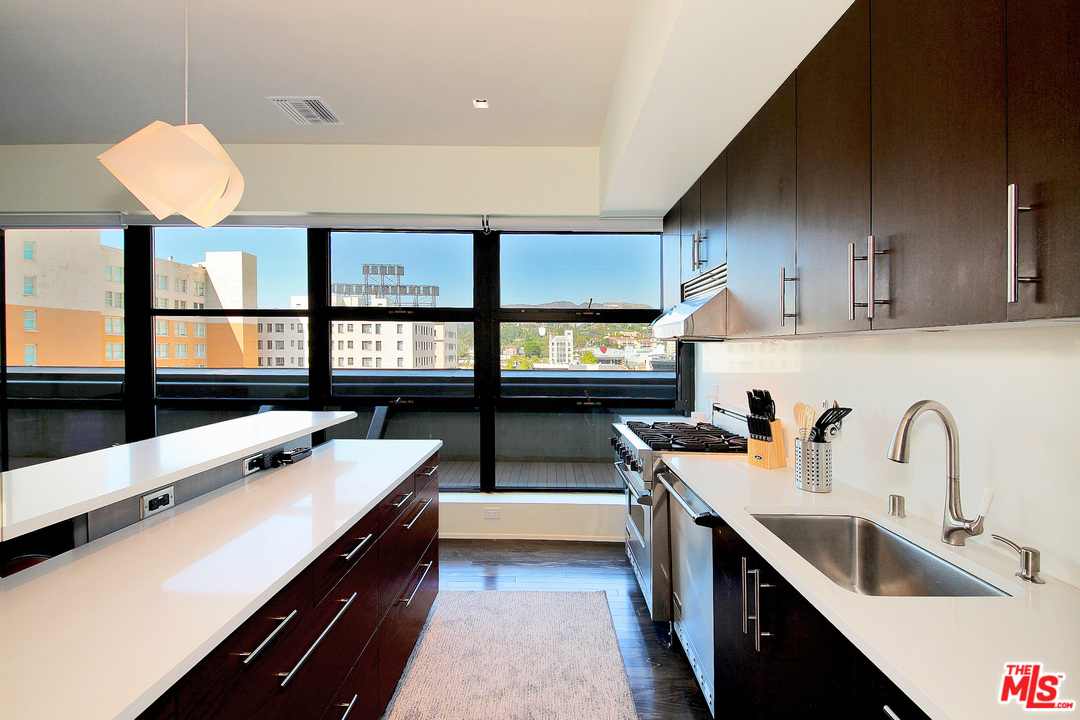1645 Vine Street, Unit 908 Los Angeles, CA 90028 - Photo 18 of 52 a kitchen with stainless steel appliances a sink stove and cabinets