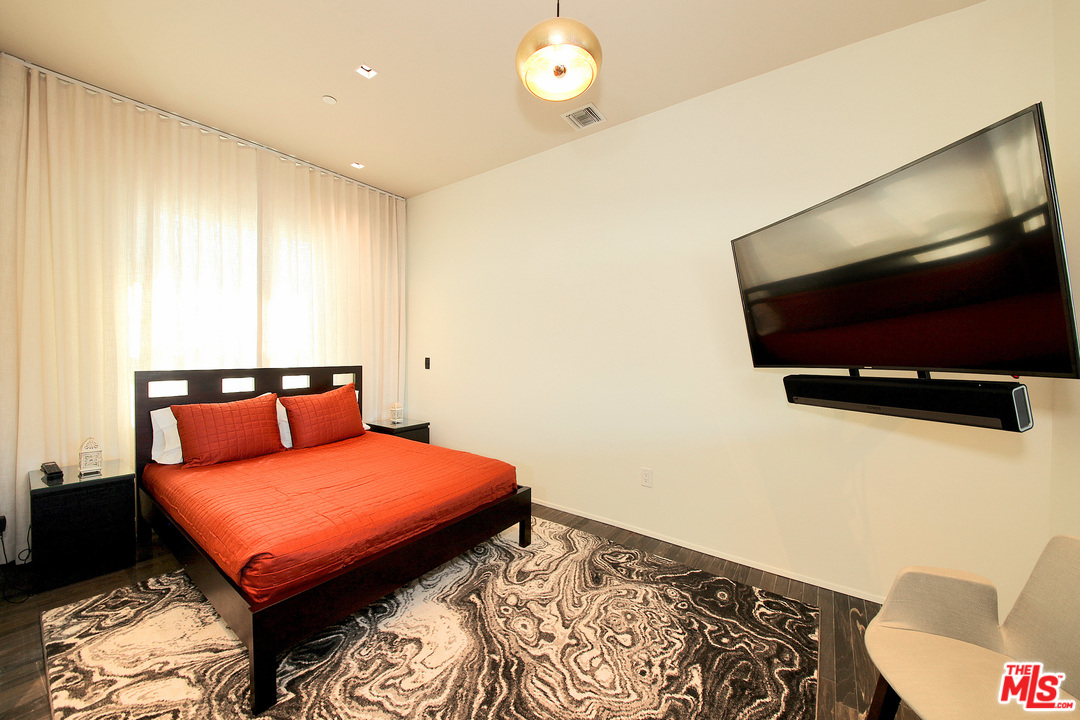 1645 Vine Street, Unit 908 Los Angeles, CA 90028 - Photo 23 of 52 a bedroom with a bed and a flat screen tv