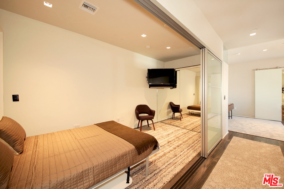 1645 Vine Street, Unit 908 Los Angeles, CA 90028 - Photo 27 of 52 a bedroom with a bed and a flat screen tv