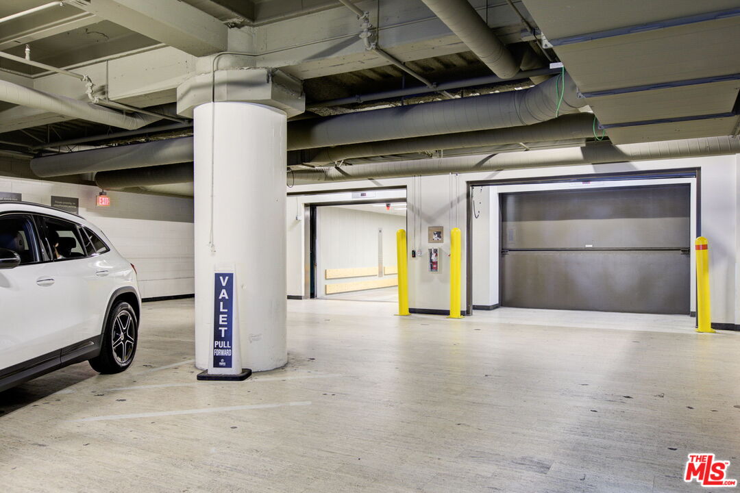 1645 Vine Street, Unit 908 Los Angeles, CA 90028 - Photo 49 of 52 a view of garage with a car parked in it