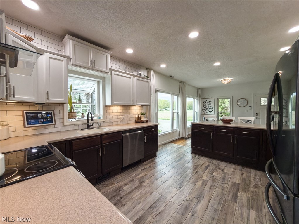 13429 West Calla Road Salem, OH 44460 - Photo 3 of 27 Kitchen featuring wood-finish flooring, recessed lighting, and a subway tile backsplash