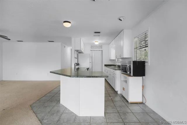a kitchen with stainless steel appliances a refrigerator sink and stove