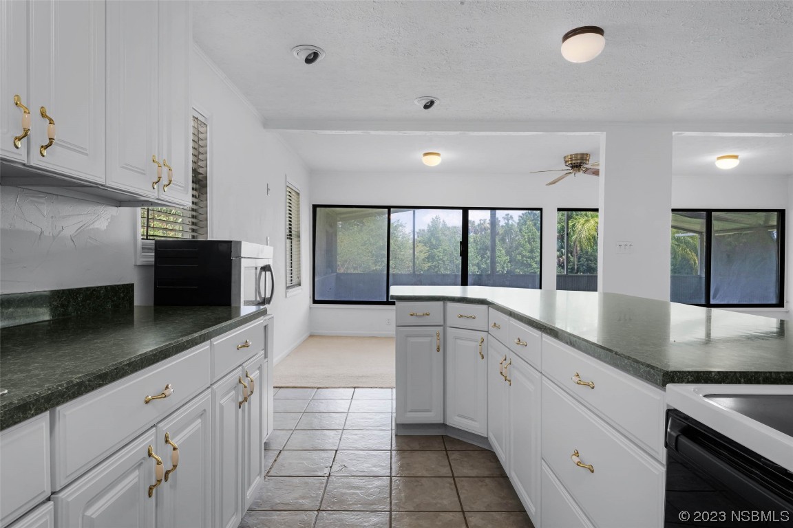 486 Detroit Terrace DeBary, FL 32713 - Photo 20 of 47 a large white kitchen with a large window and stainless steel appliances
