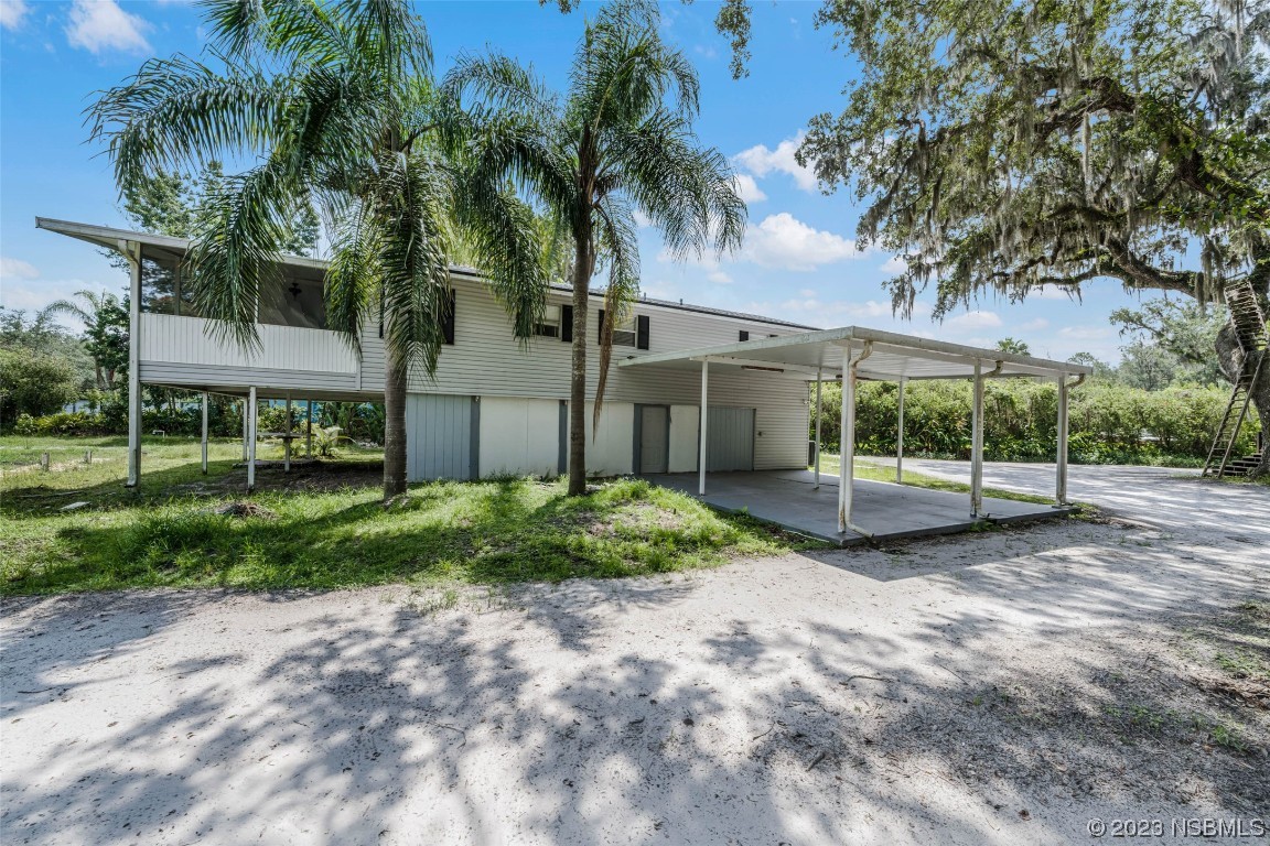 486 Detroit Terrace DeBary, FL 32713 - Photo 28 of 47 a view of a house with a yard and palm trees